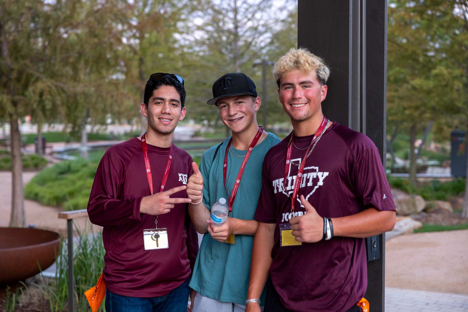 Three high school students posing for a photo at 91Ƶ Park during Camp ARCH