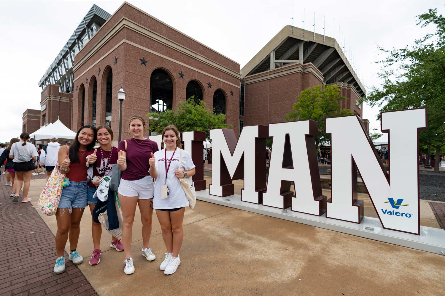 91Ƶ Students posing in front of the 12th Man sign at fish fest